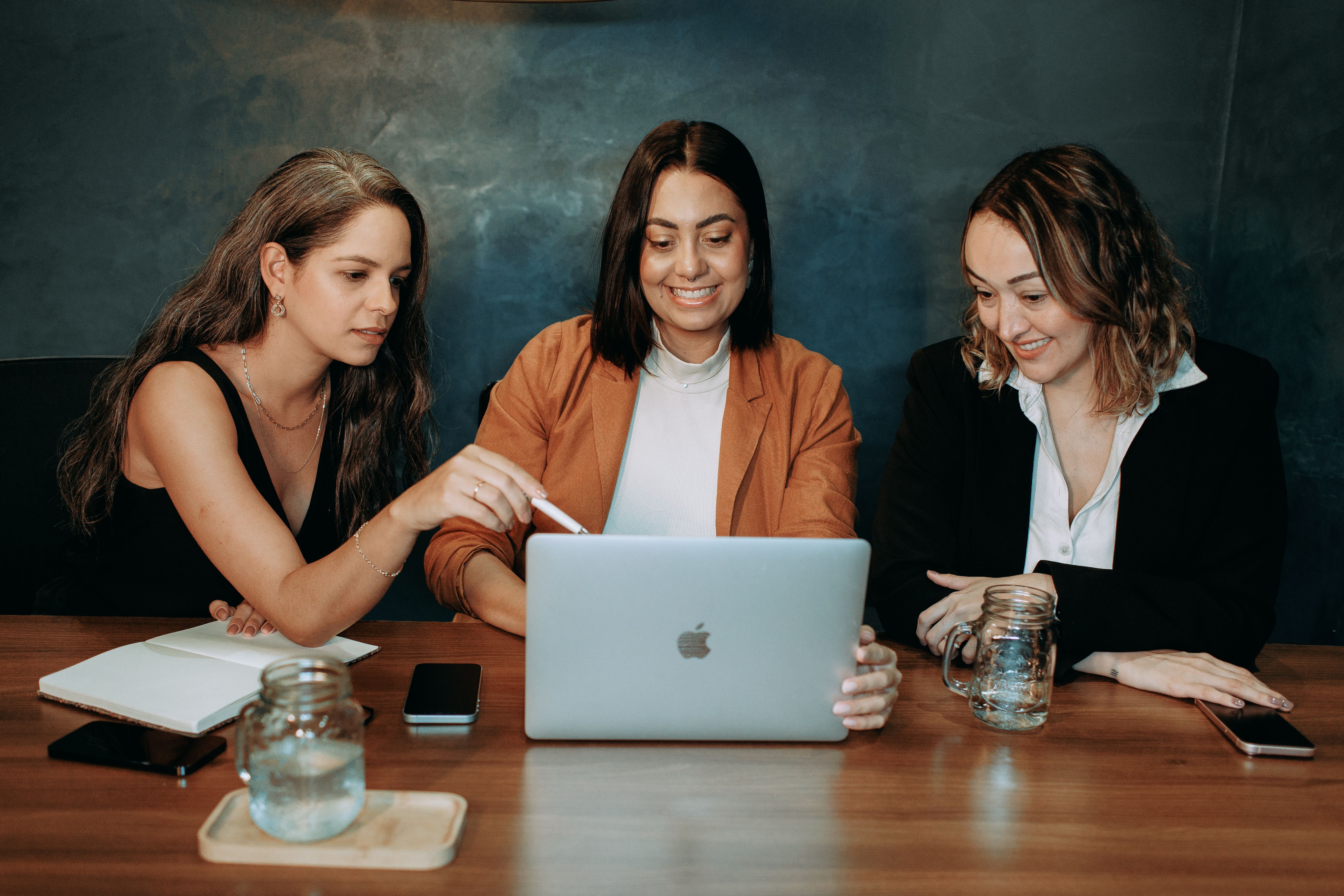 Marketing team collaborating over a laptop during a digital PR strategy meeting